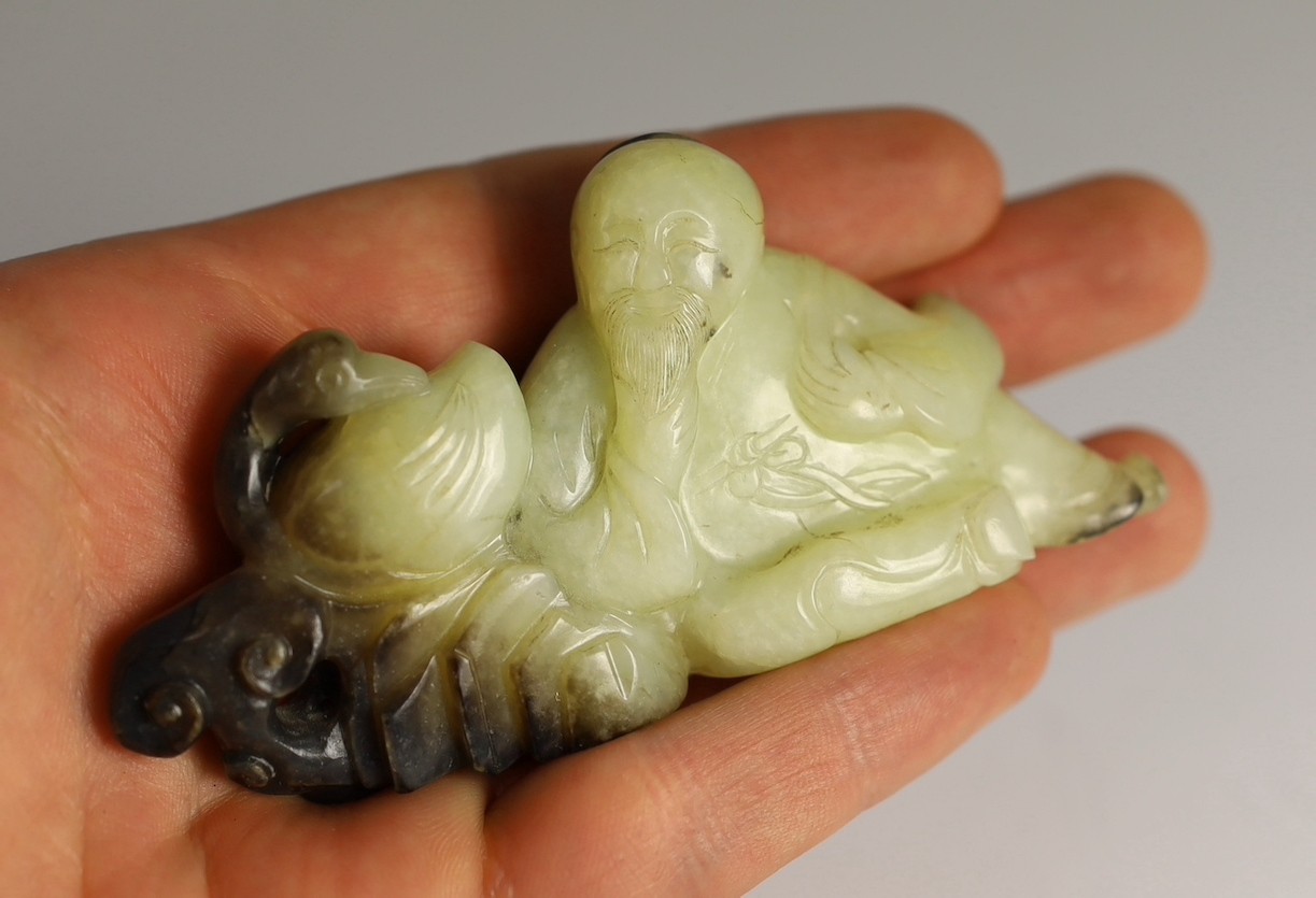 A Chinese white and black jade group of the calligrapher Wang Xizhi seated by a goose, 18th century, 9.7cm across, carved zitan wood stand